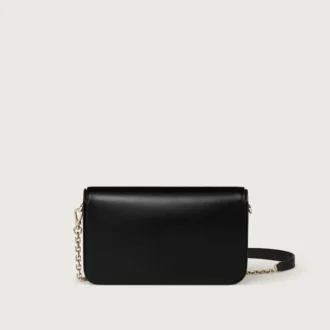 Mini-bolsa com corrente, Double C De Cartier – Pele de bezerro preta, acabamento em ouro e esmalte preto – Cartier